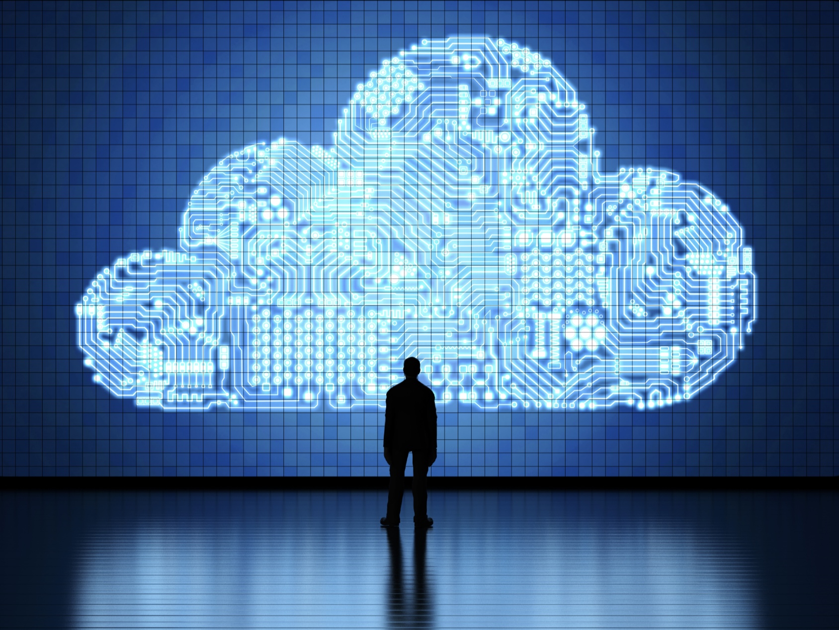 Person learning about cloud computing by looking at a futuristic image of a cloud on the wall.